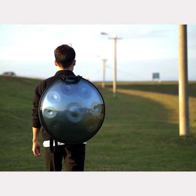 Handpanuni's founder Marco is carring his blue handpan Glacier in a transparent handpan bag